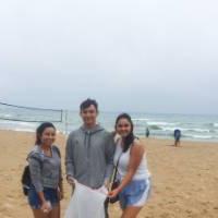 3 students pose with the trash they have picked up